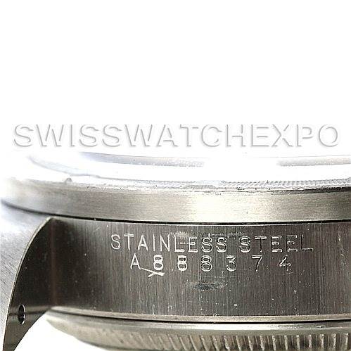 This image shows a close-up of the side of a Rolex Date 15210 Men's Stainless Steel White Dial 15210 Men's Stainless Steel White Dial model watch, highlighting the serial number and "Stainless Steel" engraving.