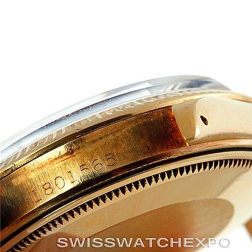 This close-up image of a Rolex Date 1500 Men's Yellow Gold Blue Dial 1500 Men's Yellow Gold Blue Dial model shows the side of the watch case and crystal.