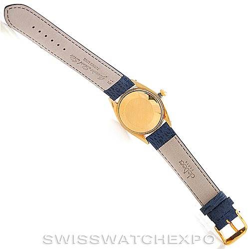 This is an overhead view of a Rolex Date 1500 Men's Yellow Gold Blue Dial 1500 Men's Yellow Gold Blue Dial model watch showing its back, leather strap, and buckle.