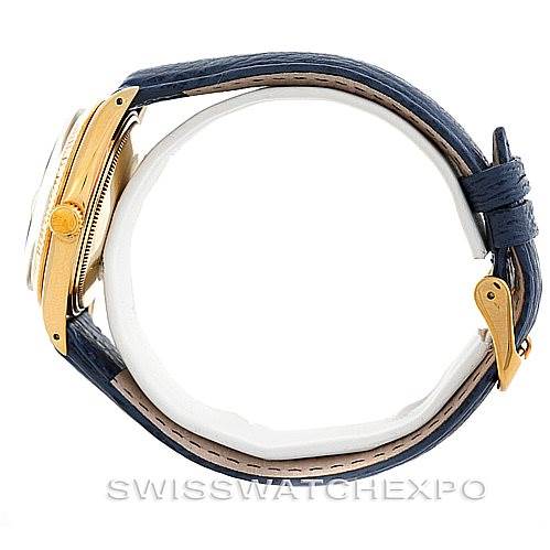 This image shows a side view of the Rolex Date 1500 Men's Yellow Gold Blue Dial 1500 Men's Yellow Gold Blue Dial model watch, highlighting its case, crown, and blue leather strap.