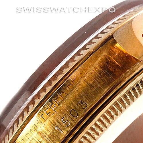 This close-up image of the Rolex Date 1503 Men's Yellow Gold Brown Dial 1503 Men's Yellow Gold Brown Dial model watch shows part of the case with engraving and the bezel.