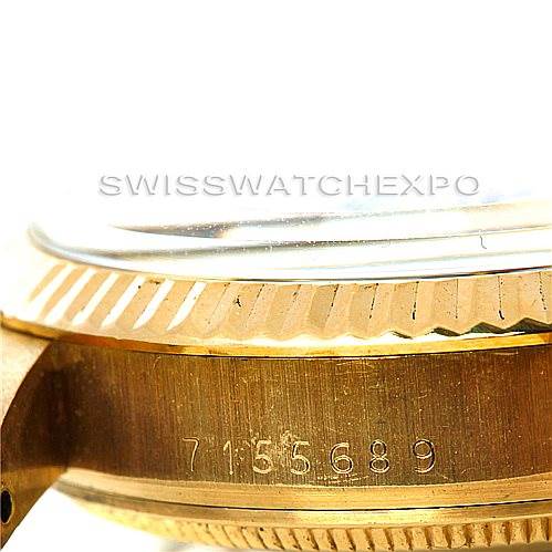 This image shows a side angle of the serial number engraving and part of the case of a Rolex Date 15037 Men's Yellow Gold Black Dial 15037 Men's Yellow Gold Black Dial model watch.