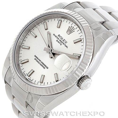 This image shows a Rolex Date 115234 Men's Stainless Steel Silver Dial 115234 Men's Stainless Steel Silver Dial model watch from an angled view, highlighting the face, bezel, crown, and part of the bracelet.