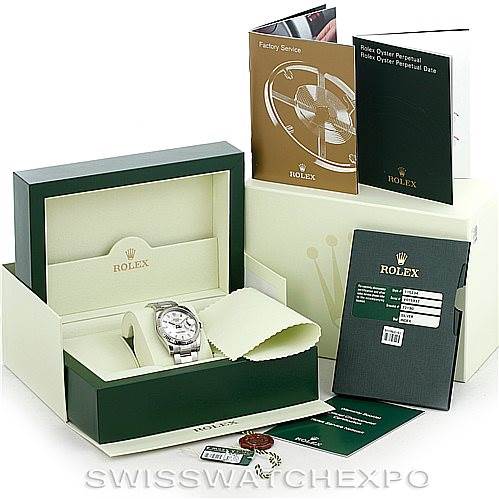 The image shows a Rolex Date 115234 Men's Stainless Steel Silver Dial 115234 Men's Stainless Steel Silver Dial model watch in its open box along with accompanying booklets and accessories.