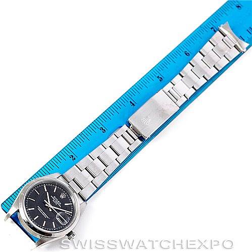 The image shows the Rolex Date 15200 Men's Stainless Steel Black Dial 15200 Men's Stainless Steel Black Dial model watch laying flat, displaying the full watch band and dial alongside a ruler.