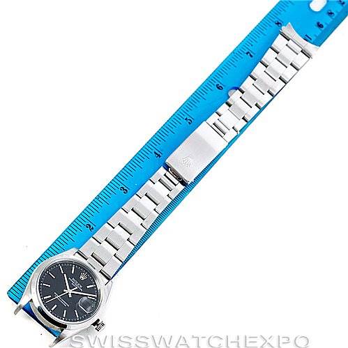 The image shows a Rolex Date 15200 Men's Stainless Steel Black Dial 15200 Men's Stainless Steel Black Dial model watch laid flat and measured against a blue ruler, displaying the face and bracelet.