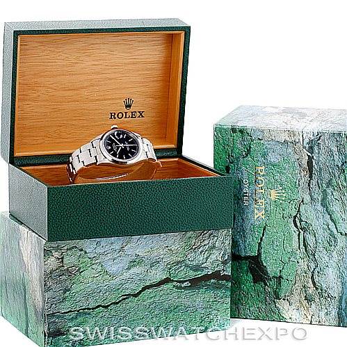 The image shows a Rolex Date 15200 Men's Stainless Steel Black Dial 15200 Men's Stainless Steel Black Dial model watch in an open green and wooden box, with the watch face partially visible.
