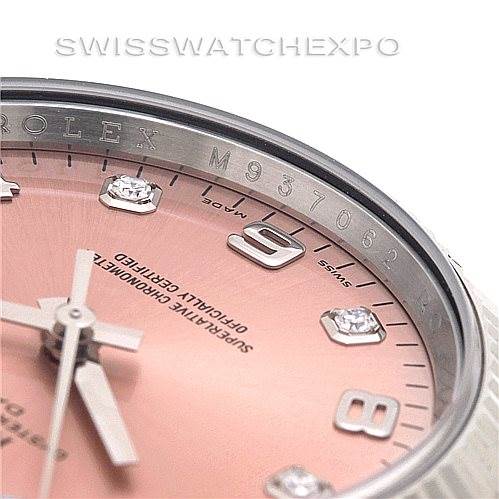 Close-up of the dial and bezel of a Rolex Date 115234 Men's Stainless Steel Pink Dial 115234 Men's Stainless Steel Pink Dial model, showing the serial number, markers, and part of the hour and minute hands.