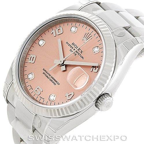 The image shows a Rolex Date 115234 Men's Stainless Steel Pink Dial 115234 Men's Stainless Steel Pink Dial model watch from a 3/4 angle, highlighting its dial, bezel, case, and part of the bracelet.