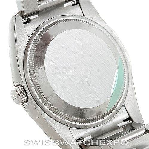 This image shows the back case and part of the bracelet of a Rolex Date 115234 Men's Stainless Steel Pink Dial 115234 Men's Stainless Steel Pink Dial model watch.