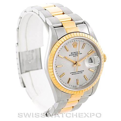 This image shows a Rolex Date 15223 Men's Steel and Gold (two tone) Silver Dial 15223 Men's Steel and Gold (two tone) Silver Dial model watch angled to display its face, gold fluted bezel, and two-tone bracelet.