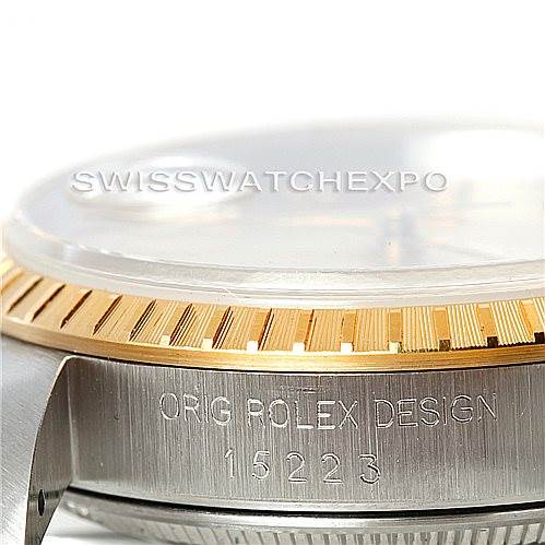 This image shows a close-up side view of the bezel, case, and engravings on a Rolex Date 15223 Men's Steel and Gold (two tone) Champagne Dial 15223 Men's Steel and Gold (two tone) Champagne Dial model.