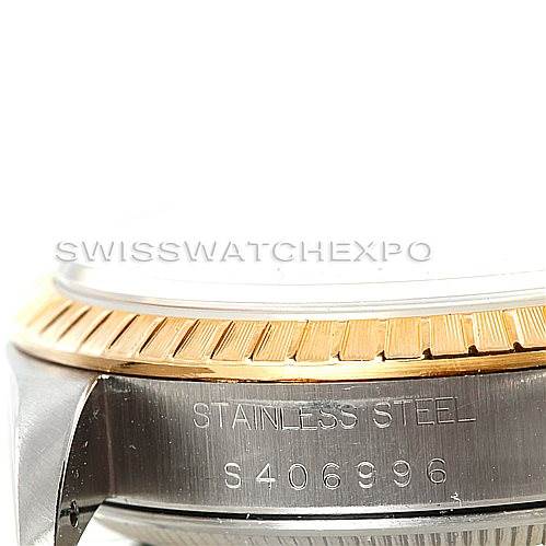 This image shows a close-up angle of the side of a Rolex Date 15223 Men's Steel and Gold (two tone) Blue Dial 15223 Men's Steel and Gold (two tone) Blue Dial model watch, focusing on the stainless steel engraved section and the bezel.
