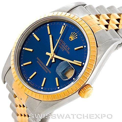 The image shows a Rolex Date 15223 Men's Steel and Gold (two tone) Blue Dial 15223 Men's Steel and Gold (two tone) Blue Dial model watch at an angled front view, highlighting the blue dial, gold bezel, and part of the metal bracelet.