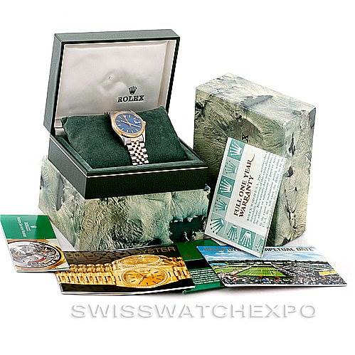 The image shows a Rolex Date 15223 Men's Steel and Gold (two tone) Blue Dial 15223 Men's Steel and Gold (two tone) Blue Dial model watch at an angle inside its open box, along with additional packaging and booklets.