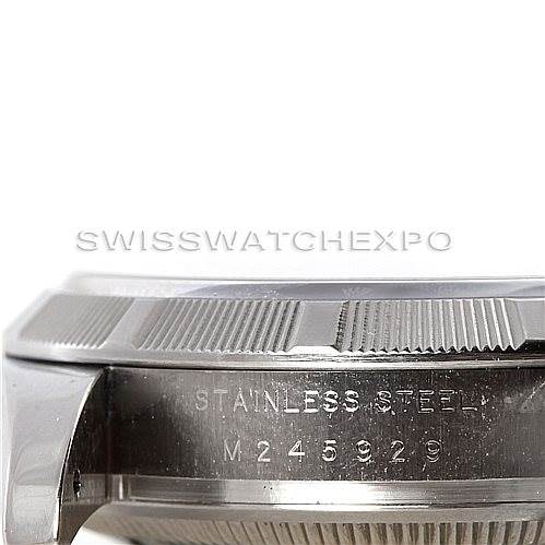 This image shows a side view of the bezel and case of a Rolex Date 115210 Men's Stainless Steel Blue Dial 115210 Men's Stainless Steel Blue Dial model watch, highlighting the serial number engraved on the stainless steel.