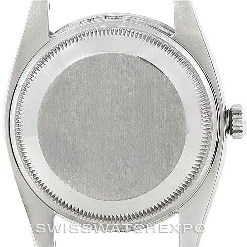 This image shows the back case and crown of a Rolex Date 115210 Men's Stainless Steel Blue Dial 115210 Men's Stainless Steel Blue Dial model watch from a rear angle.