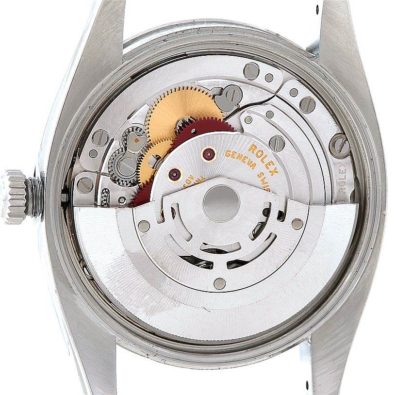 This image shows the internal mechanical movement of a Rolex Date 115200 Men's Stainless Steel Blue Dial 115200 Men's Stainless Steel Blue Dial model watch from the back, including gears and the rotor.
