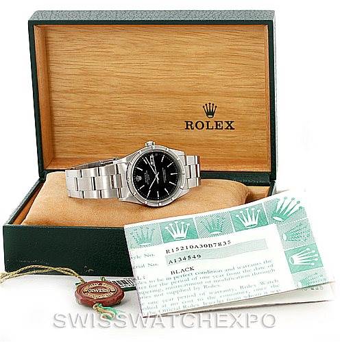 The image shows a Rolex Date 15210 Men's Stainless Steel Black Dial 15210 Men's Stainless Steel Black Dial model watch in its open box with accompanying documentation and tags.