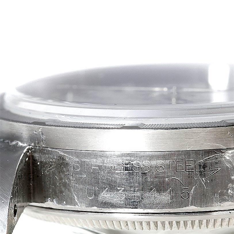 The image shows a close-up of the side casing and bezel of a Rolex Date 15210 Men's Stainless Steel White Dial 15210 Men's Stainless Steel White Dial model, focusing on the stainless steel material and serial number.