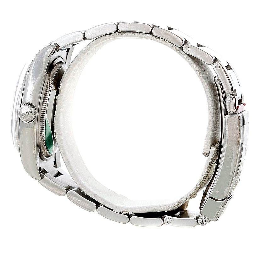 This image shows a Rolex Date 115200 Men's Stainless Steel Silver Dial 115200 Men's Stainless Steel Silver Dial model watch from a side profile, highlighting the crown, case, and bracelet.