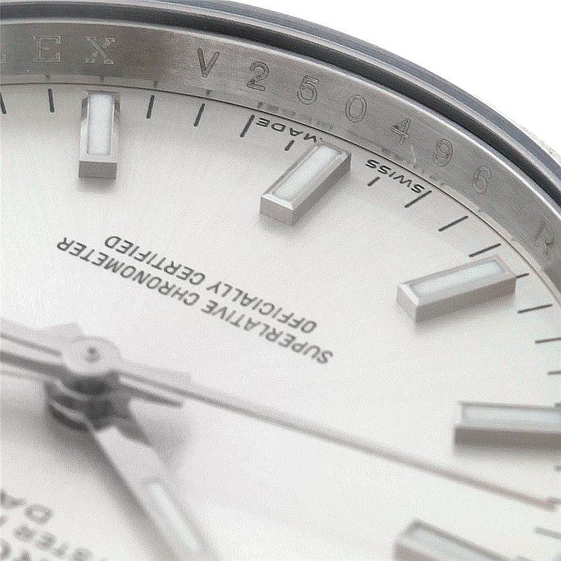 The image shows a close-up of the face of a Rolex Date 115200 Men's Stainless Steel Silver Dial 115200 Men's Stainless Steel Silver Dial model, highlighting the dial, markers, hands, and part of the bezel.