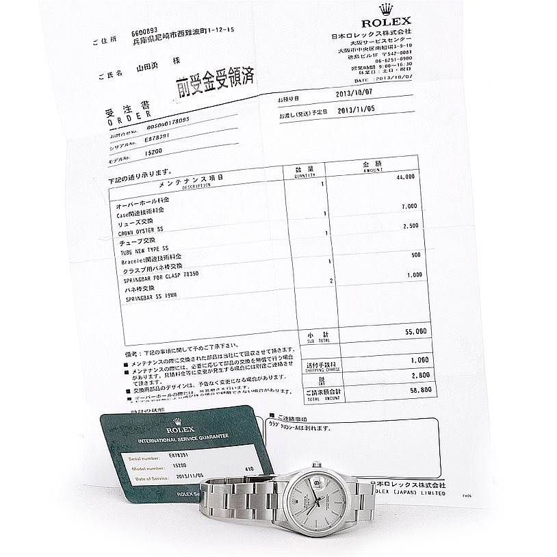 The image shows a Rolex Date 15200 Men's Stainless Steel Silver Dial 15200 Men's Stainless Steel Silver Dial watch and its warranty card, viewed from the front alongside paperwork.