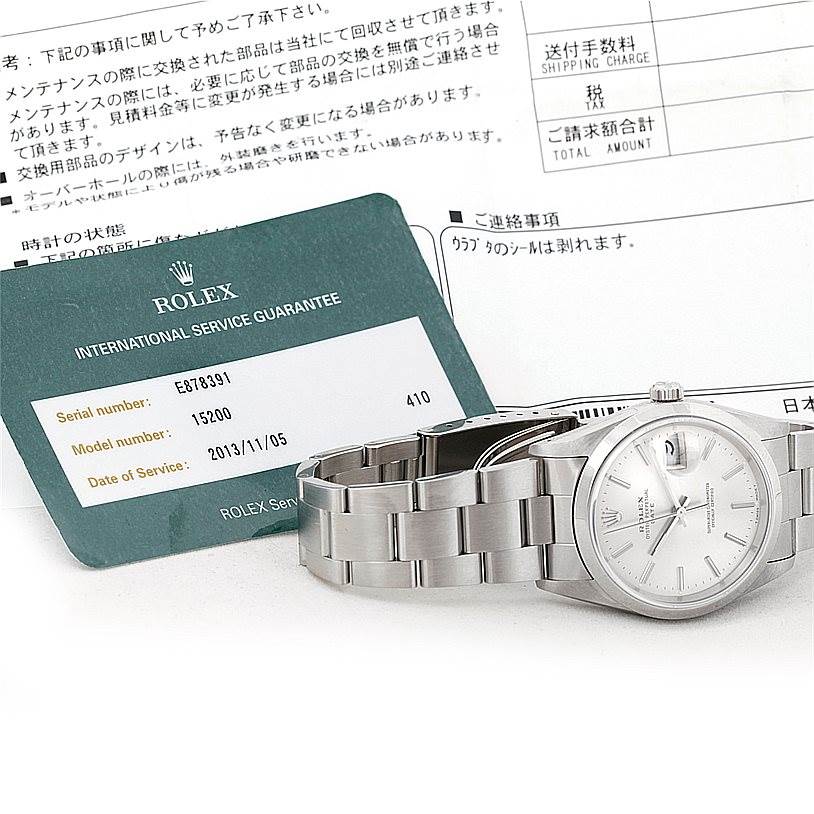 The image shows a Rolex Date 15200 Men's Stainless Steel Silver Dial 15200 Men's Stainless Steel Silver Dial model watch with its bracelet and a service guarantee card visible.
