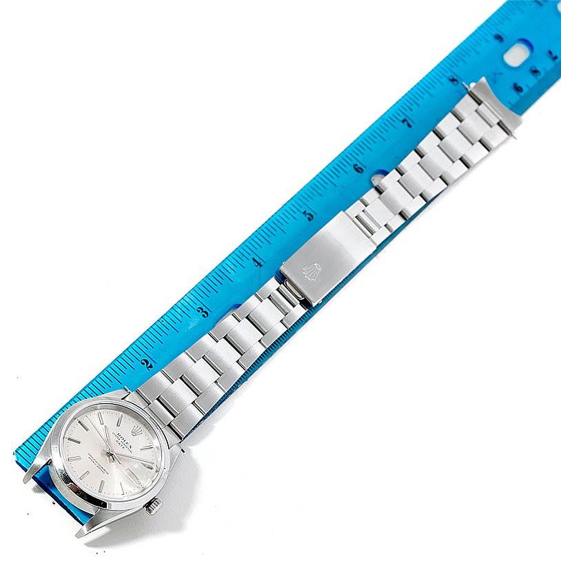 The image shows a Rolex Date 15200 Men's Stainless Steel Silver Dial 15200 Men's Stainless Steel Silver Dial model watch laid flat, displaying the face, bracelet, and clasp alongside a ruler for size reference.