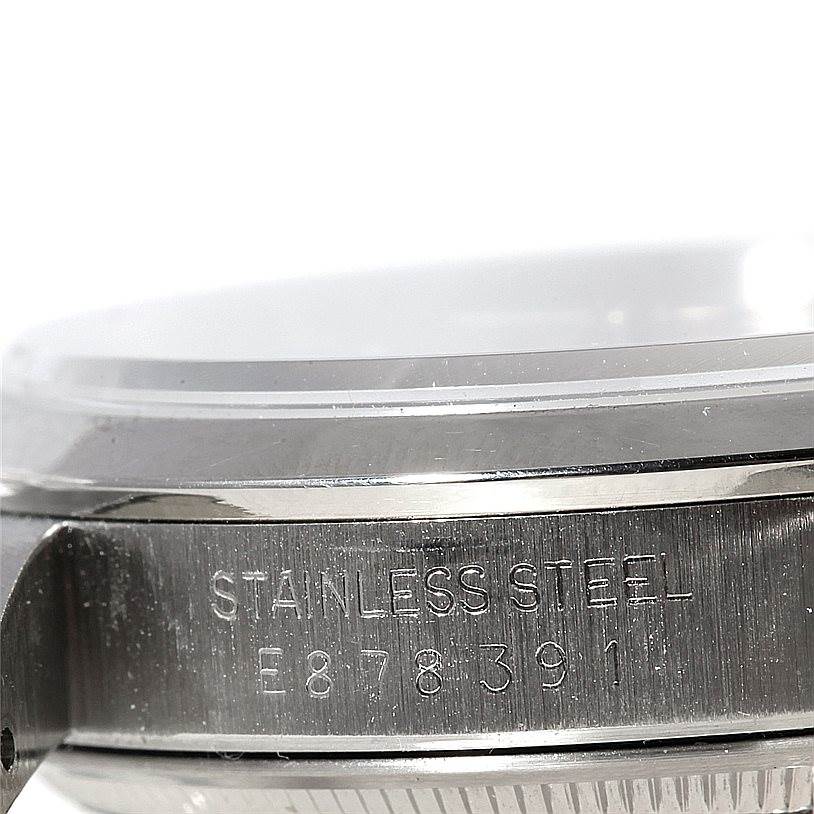 This close-up image shows the stainless steel side of a Rolex Date 15200 Men's Stainless Steel Silver Dial 15200 Men's Stainless Steel Silver Dial watch with visible serial and model engravings.
