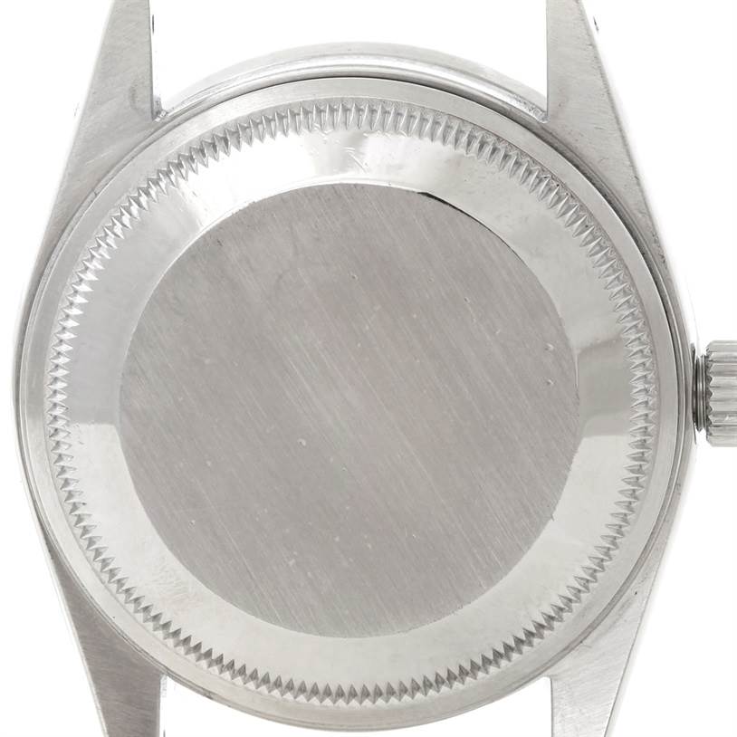 The image shows the case back and part of the crown of a Rolex Date 15210 Men's Stainless Steel Black Dial 15210 Men's Stainless Steel Black Dial model watch.