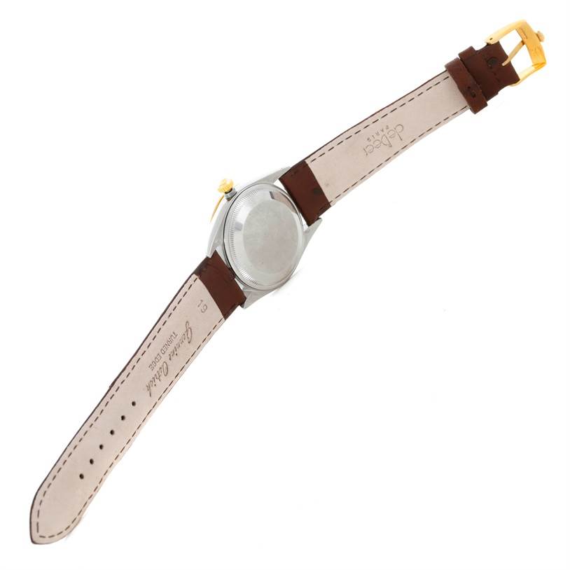 The image shows the back view of a Rolex Date 15203 Men's Steel and Gold (two tone) Grey Dial 15203 Men's Steel and Gold (two tone) Grey Dial model watch with an open brown leather strap.