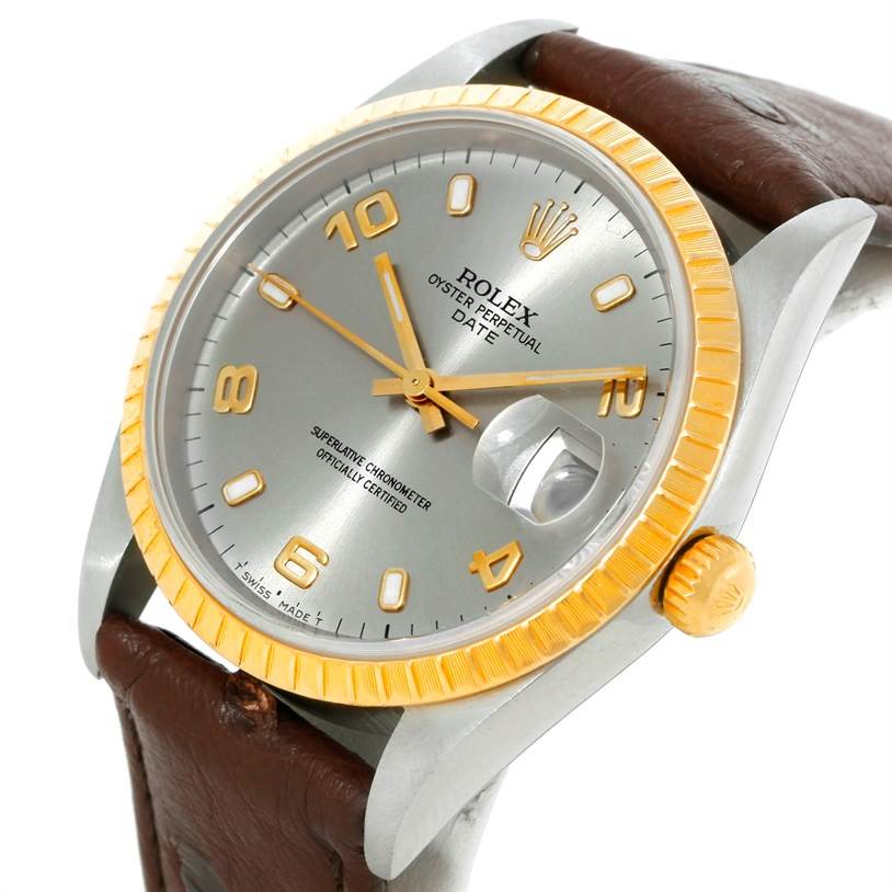 This image shows a close-up angle of the Rolex Date 15203 Men's Steel and Gold (two tone) Grey Dial 15203 Men's Steel and Gold (two tone) Grey Dial model watch, highlighting its dial, bezel, crown, and part of the leather strap.