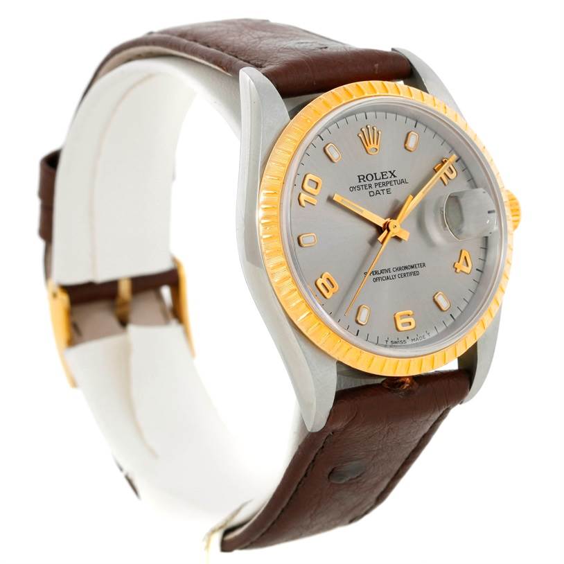 This Rolex Date 15203 Men's Steel and Gold (two tone) Grey Dial 15203 Men's Steel and Gold (two tone) Grey Dial model watch is shown at a three-quarter angle, highlighting its face, bezel, crown, and leather strap.