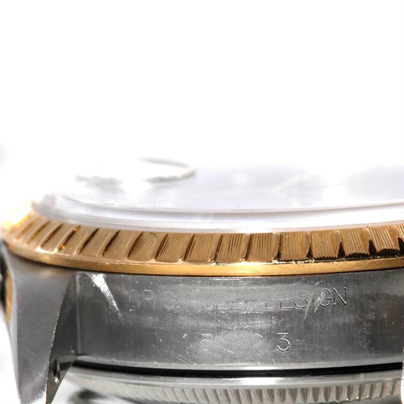 This close-up angle shows the side of a Rolex Date 15203 Men's Steel and Gold (two tone) Grey Dial 15203 Men's Steel and Gold (two tone) Grey Dial watch, highlighting its bezel, case, and part of the crystal.