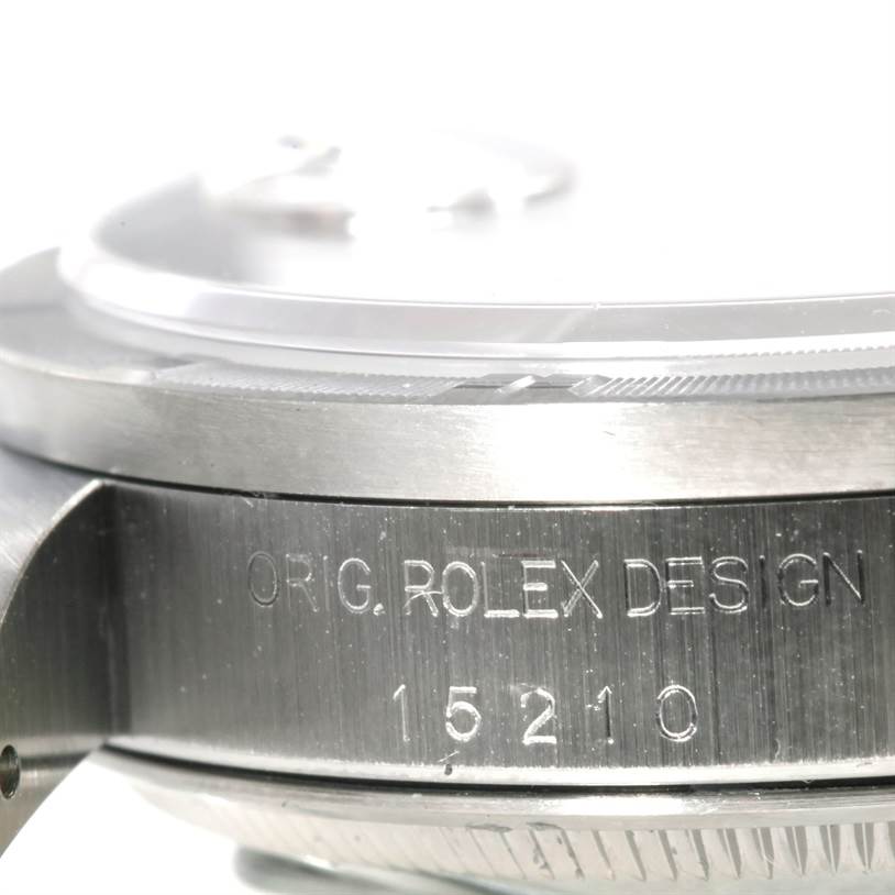 The image shows a close-up of the side of the Rolex Date 15210 Men's Stainless Steel Pink Dial 15210 Men's Stainless Steel Pink Dial watch, focusing on the engraved text and part of the bezel.