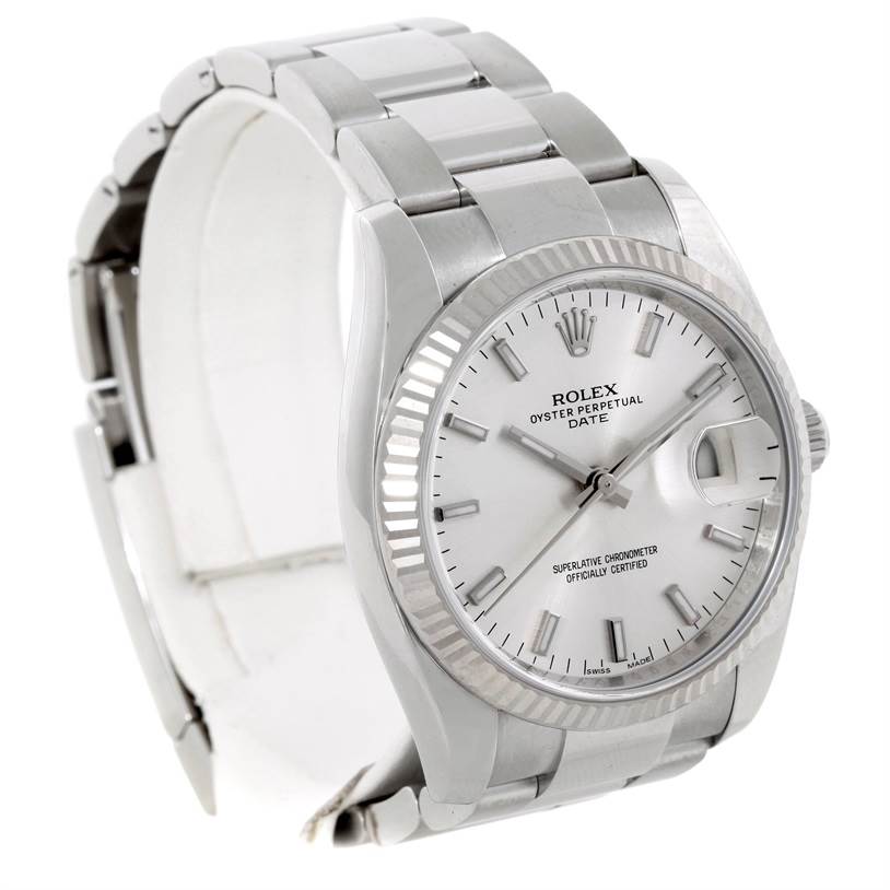 The Rolex Date 115234 Men's Stainless Steel Silver Dial 115234 Men's Stainless Steel Silver Dial watch is shown at a slight angle from the front, showcasing the dial, bezel, bracelet, and partially open clasp.