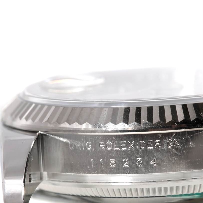 This image shows an angled close-up view of the side and bezel of the Rolex Date 115234 Men's Stainless Steel Silver Dial 115234 Men's Stainless Steel Silver Dial model watch.