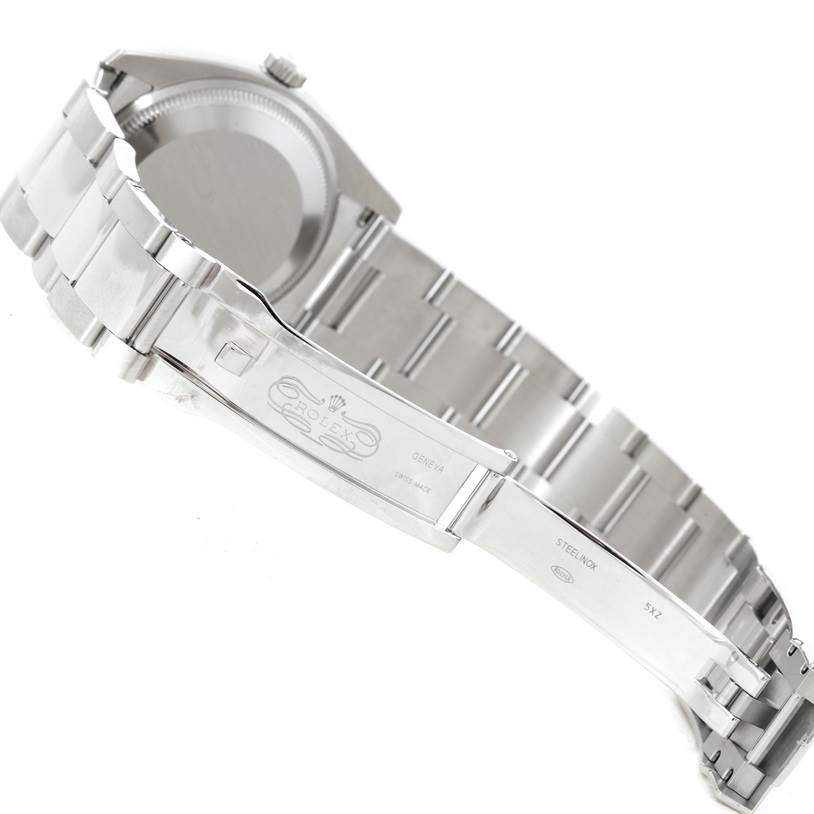 The image shows the side angle and back of a Rolex Date 115234 Men's Stainless Steel Silver Dial 115234 Men's Stainless Steel Silver Dial model watch, highlighting its clasp and bracelet.