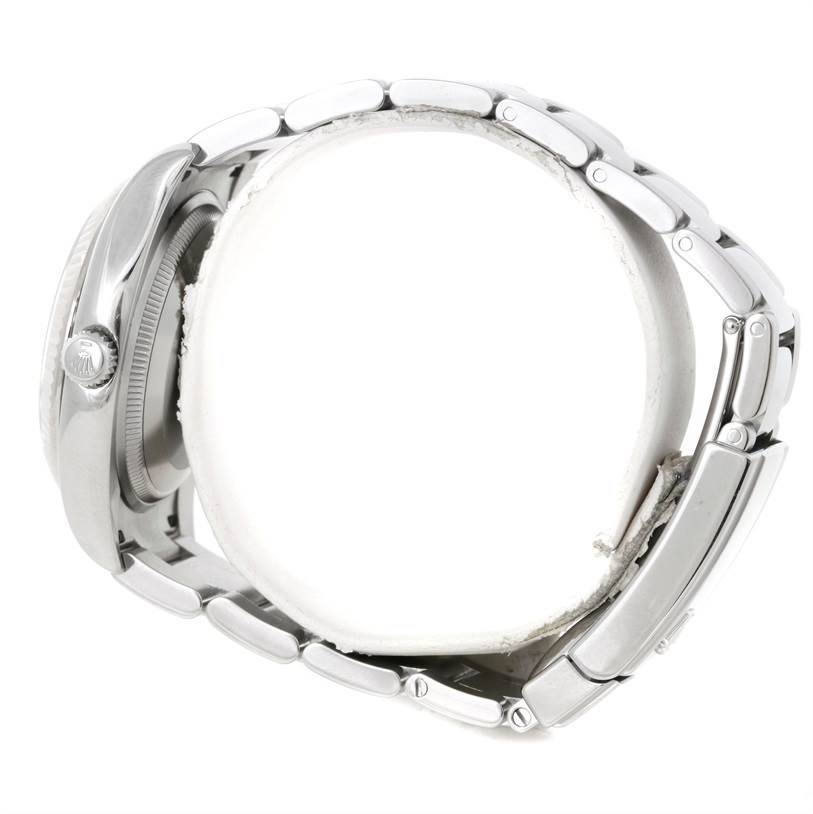 The image shows a Rolex Date 115234 Men's Stainless Steel Silver Dial 115234 Men's Stainless Steel Silver Dial model watch from a side angle, highlighting its bracelet and casing with the crown visible.