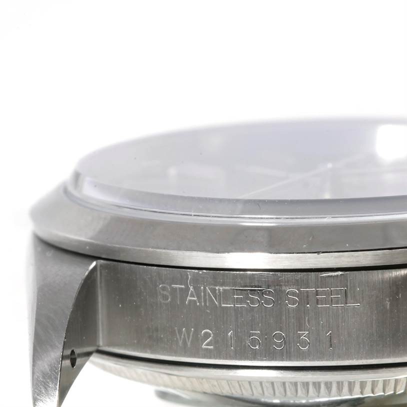 This image shows a close-up side view of the case and bezel of a Rolex Date 15200 Men's Stainless Steel Blue Dial 15200 Men's Stainless Steel Blue Dial model, highlighting the stainless steel engraving and serial number.