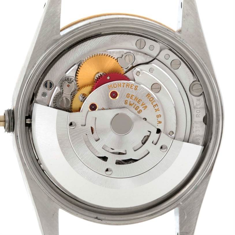 This image shows the open back view of a Rolex Date 15223 Men's Steel and Gold (two tone) Champagne Dial 15223 Men's Steel and Gold (two tone) Champagne Dial model, revealing the inner mechanical movement and gears.