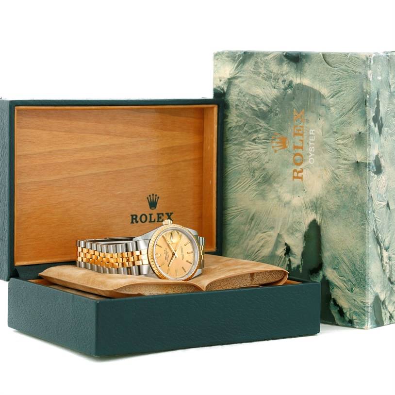 This is an angled view of a Rolex Date 15223 Men's Steel and Gold (two tone) Champagne Dial 15223 Men's Steel and Gold (two tone) Champagne Dial model watch inside an open Rolex box with the outer packaging visible.