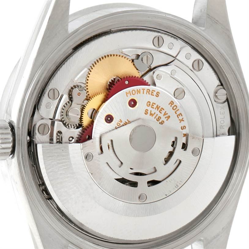 The image shows the back view of a Rolex Date 15210 Men's Stainless Steel Black Dial 15210 Men's Stainless Steel Black Dial model, highlighting its intricate automatic movement and internal gears.