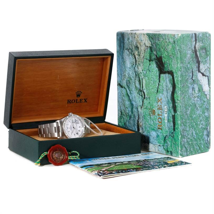 The image shows a Rolex Date 15210 Men's Stainless Steel White Dial 15210 Men's Stainless Steel White Dial model watch in its open box, with the outer packaging and accessories displayed beside it.