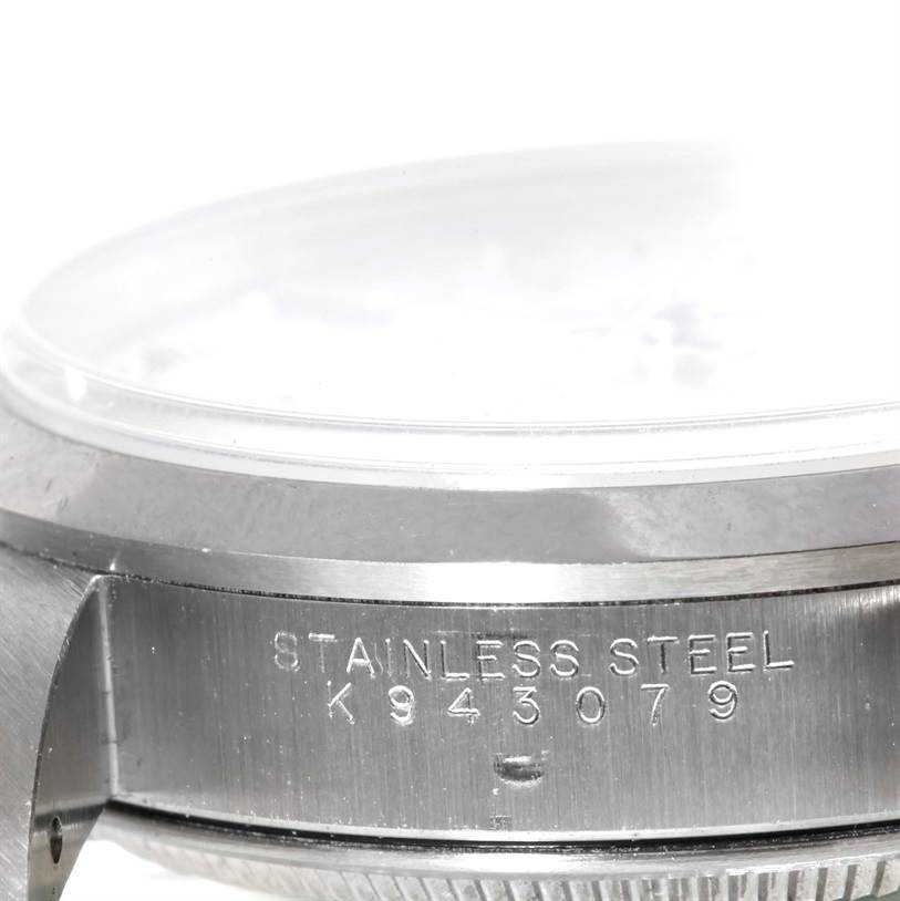 The image shows a close-up side view of the case and part of the crystal of a Rolex Date 15200 Men's Stainless Steel Silver Dial 15200 Men's Stainless Steel Silver Dial model watch, highlighting the serial number on the stainless steel.