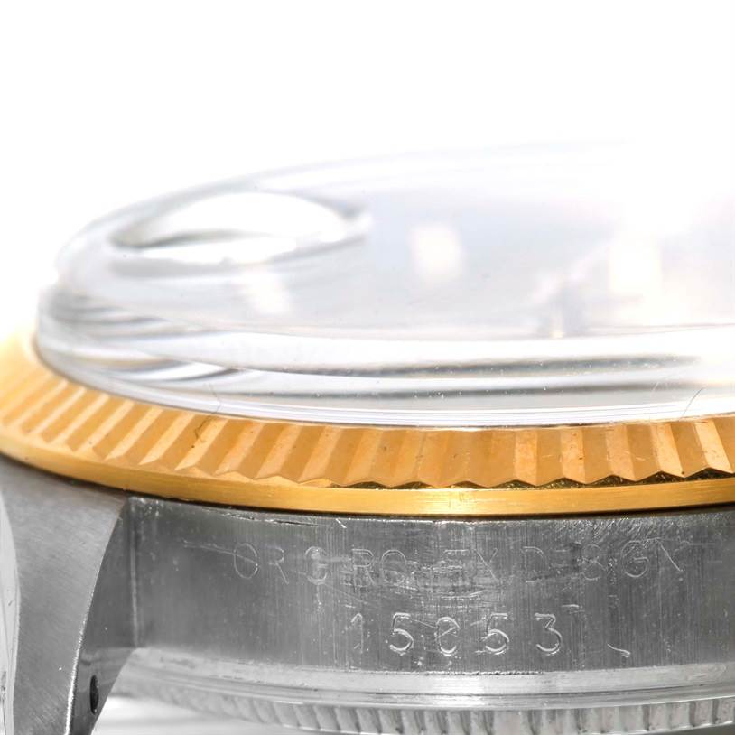 This is a close-up side angle of the Rolex Date 15053 Men's Stainless Steel Champagne Dial 15053 Men's Stainless Steel Champagne Dial watch model, showing its bezel, case, and glass crystal.