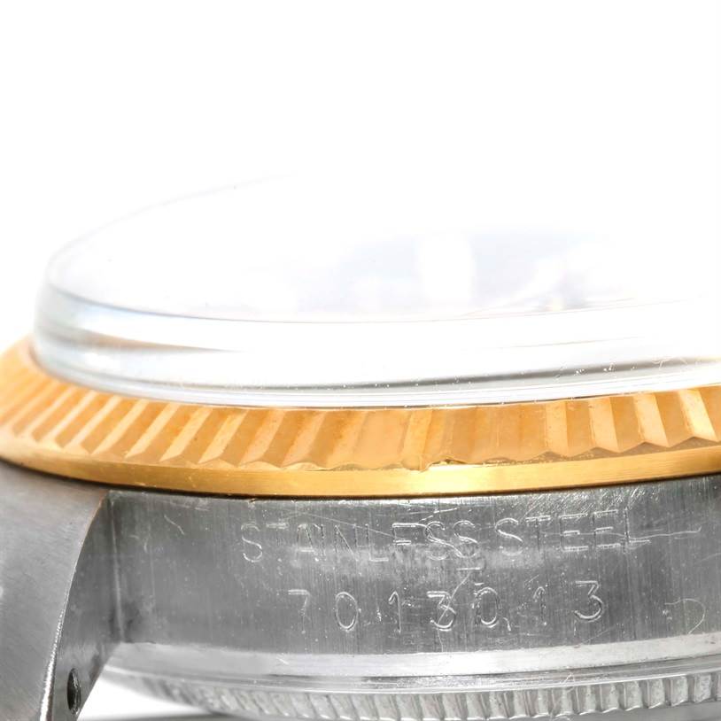 This close-up image shows the side view of the bezel and case, including the serial number engraving, of a Rolex Date 15053 Men's Stainless Steel Champagne Dial 15053 Men's Stainless Steel Champagne Dial watch.