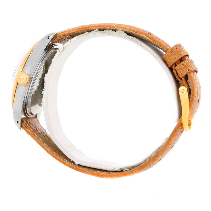 This image shows a side view of a Rolex Date 15053 Men's Stainless Steel Champagne Dial 15053 Men's Stainless Steel Champagne Dial model watch, featuring the case, crown, and leather strap.