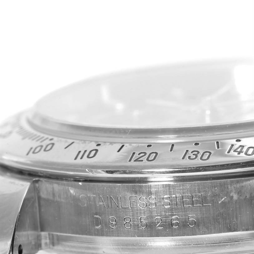This image shows a close-up angle of the bezel and serial number engraving on a Rolex Daytona 116520 Men's Stainless Steel Black Dial 116520 Men's Stainless Steel Black Dial watch.